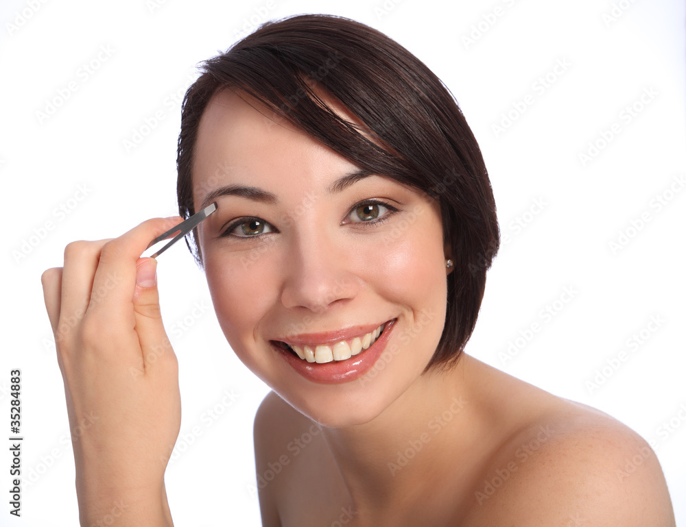 Beautiful woman plucking eyebrow with tweezers Beautiful woman plucking eyebrow with tweezers