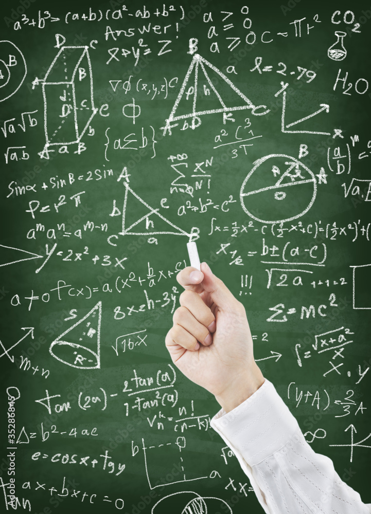 Hand writing maths formula on greenboard Hand writing maths formula on greenboard