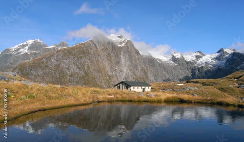 Mountains and hut lake reflection © teabum