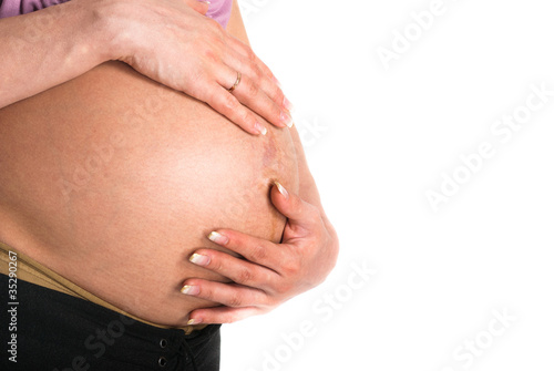Stomach of the pregnant woman on a white background