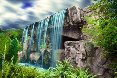 moving clouds over waterfall