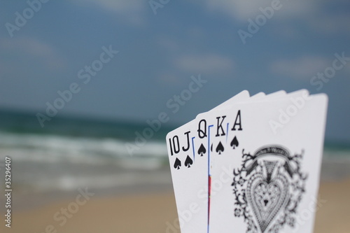 Poker hand - Royal Flush, with beach background