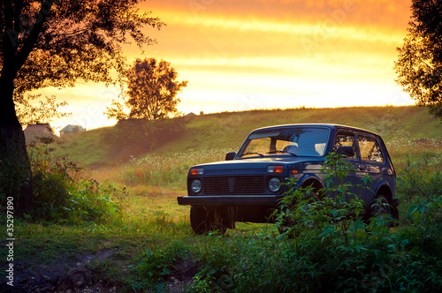 Blue SUV on a beautiful sunset photo