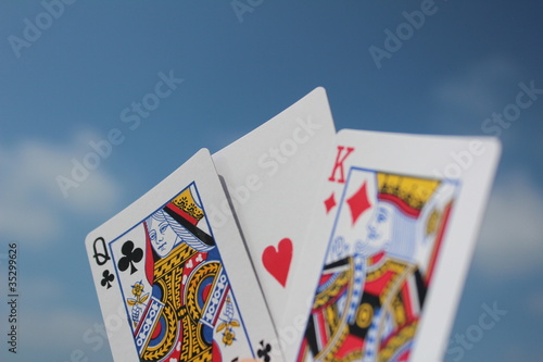 Playing cards - the king loves the queen, with sky background