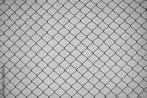iron net and white cement wall