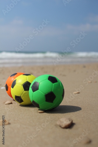 Three colorful balls at the beach