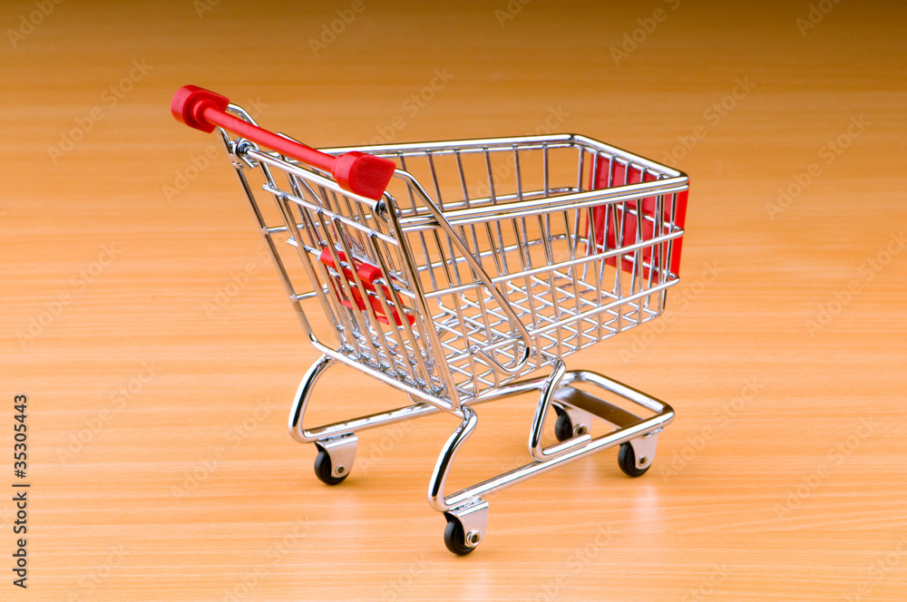 Mini shopping cart against gradient background