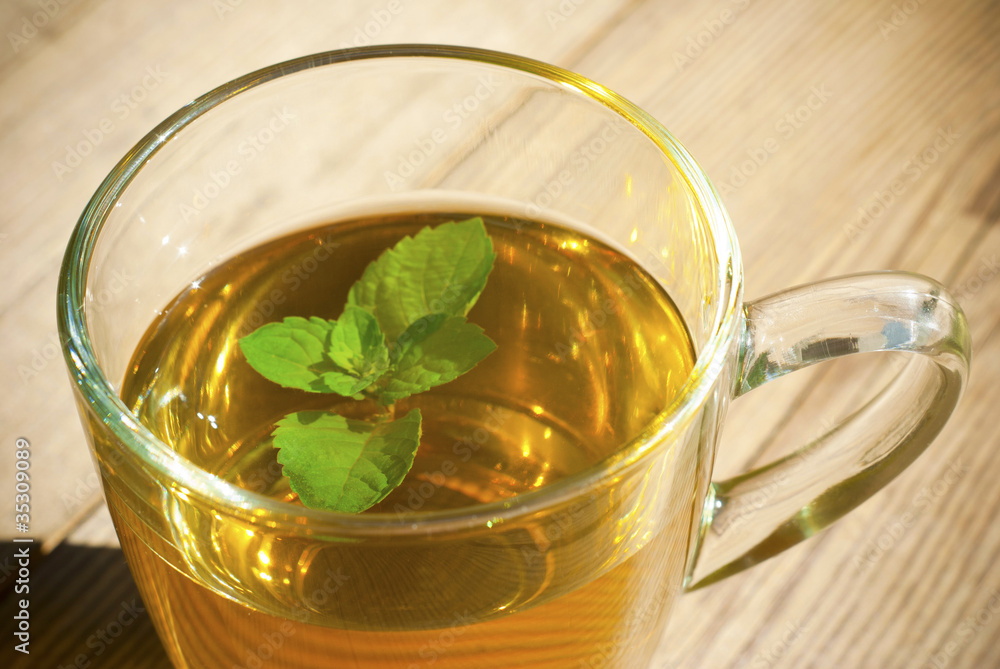 mint tea and mint leaf on old wooden table mint tea and mint leaf on old wooden table