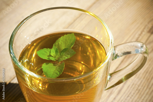 mint tea and mint leaf on old wooden table