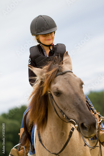 Horse riding - little girl is riding a horse