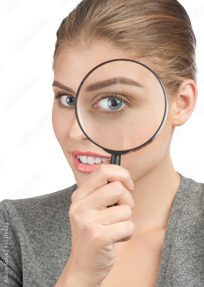 Woman looking through a magnifying glass Woman looking through a magnifying glass