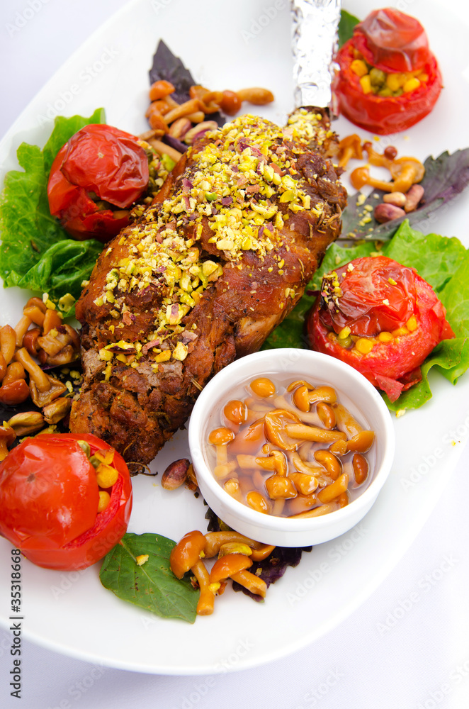 Lamb leg served in the plate Lamb leg served in the plate