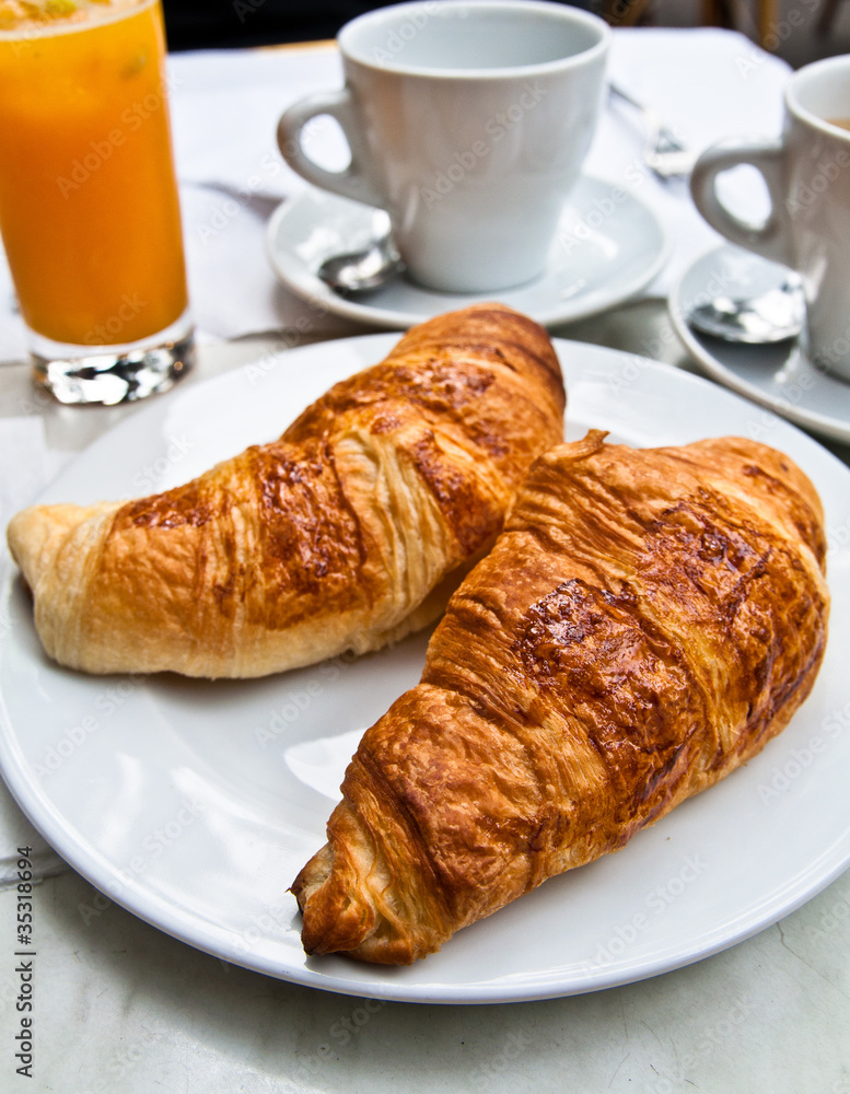 Breakfast with coffee and croissants on table Breakfast with coffee and croissants on table