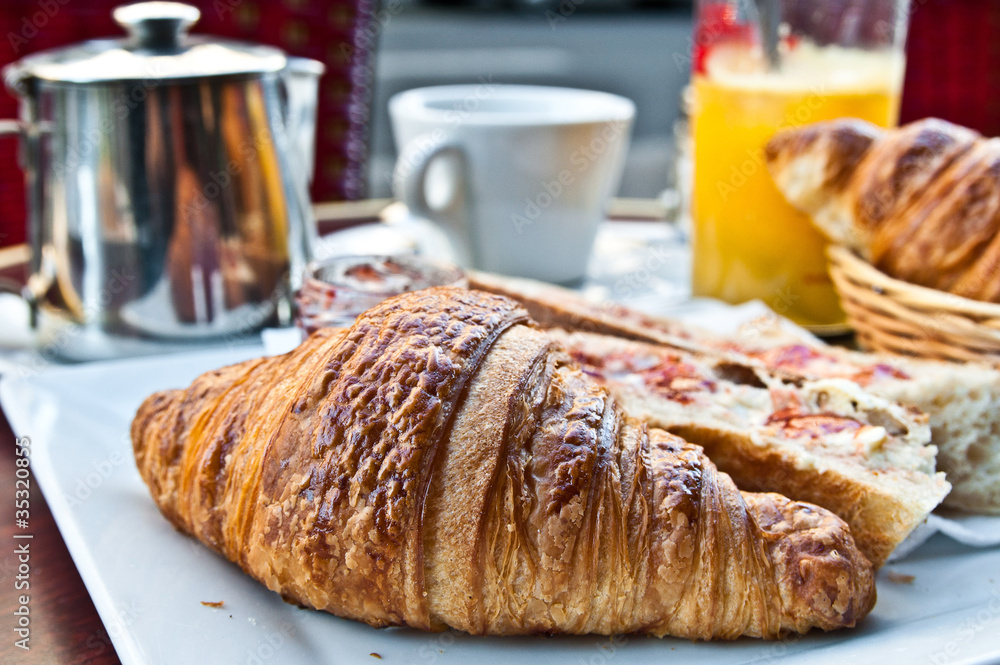 Breakfast with coffee and croissants on table Breakfast with coffee and croissants on table