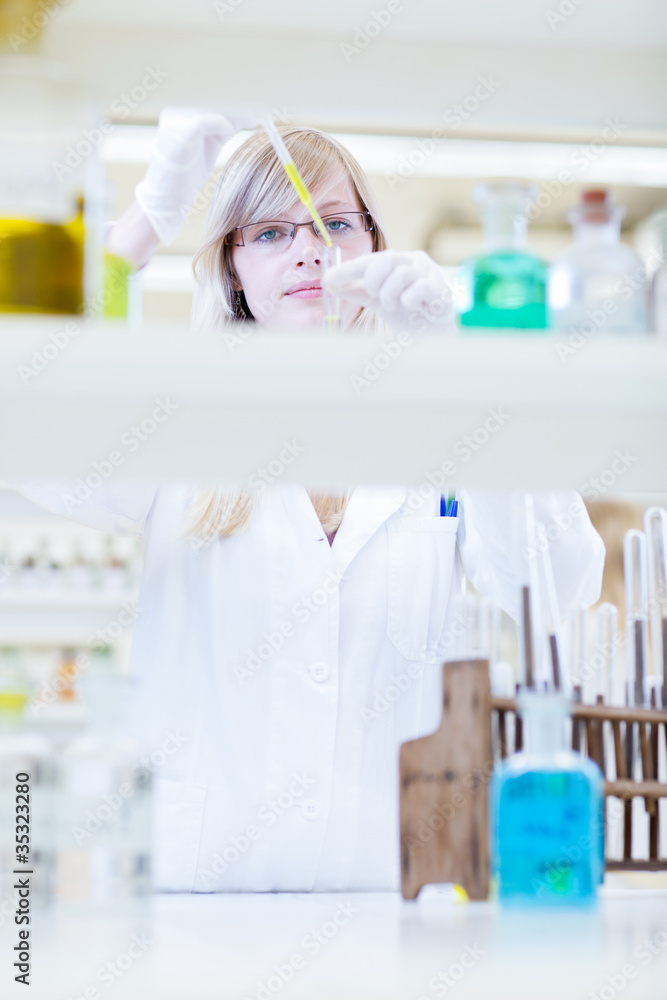 female researcher carrying out research in a lab female researcher carrying out research in a lab