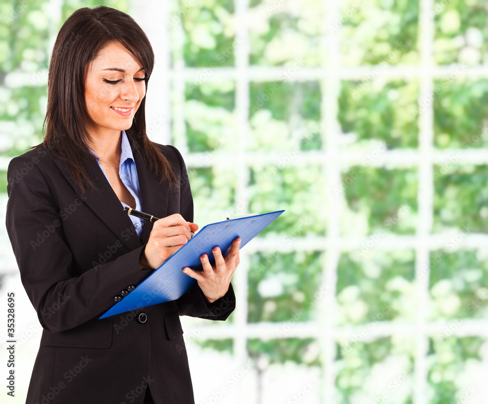 Fototapeta premium Businesswoman writing some documents