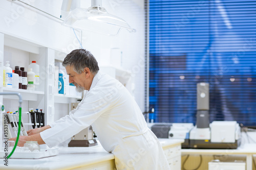 senior male researcher carrying out scientific research in a lab