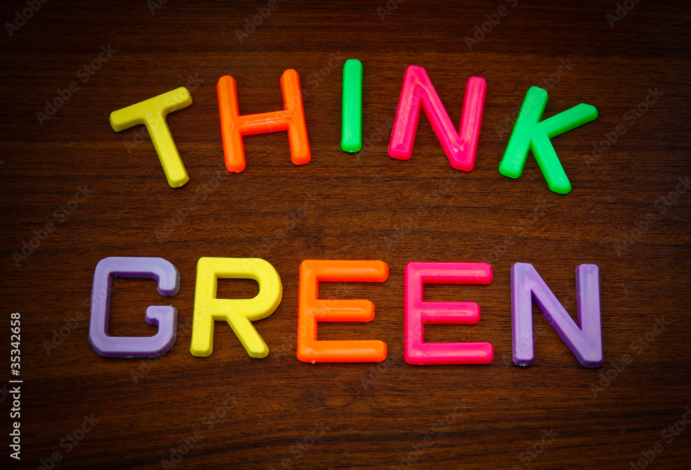 Obraz premium Think green in colorful toy letters on wood background