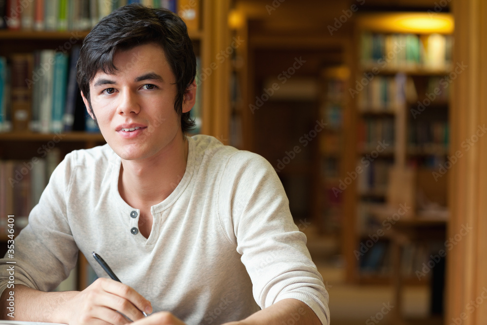 Fototapeta premium Student holding a pen
