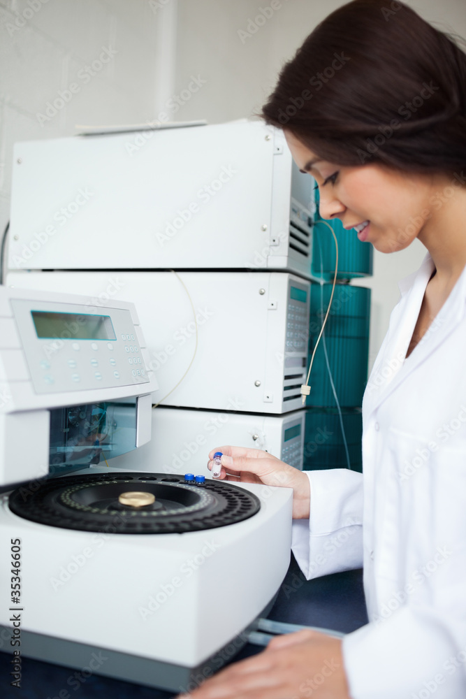 Laboratory assistant using a centrifuge Laboratory assistant using a centrifuge