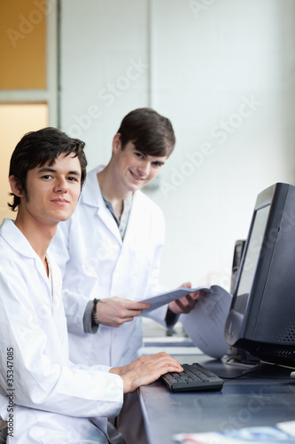 Portrait of male scientists with a monitor