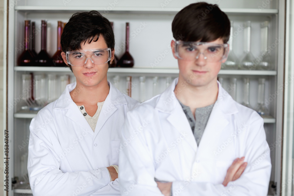 Serious male scientists posing