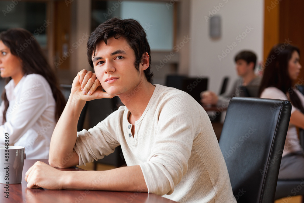 Young man sitting with a cup of tea Young man sitting with a cup of tea