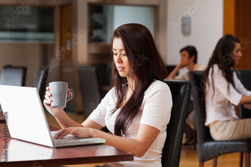 Cute woman using a notebook