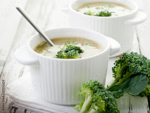 broccoli soup on bowl over wood background