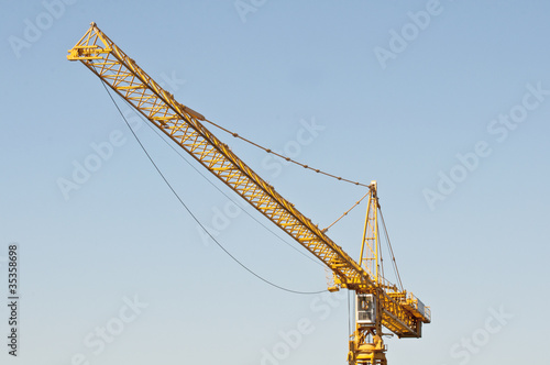 Yellow crane over blue sky