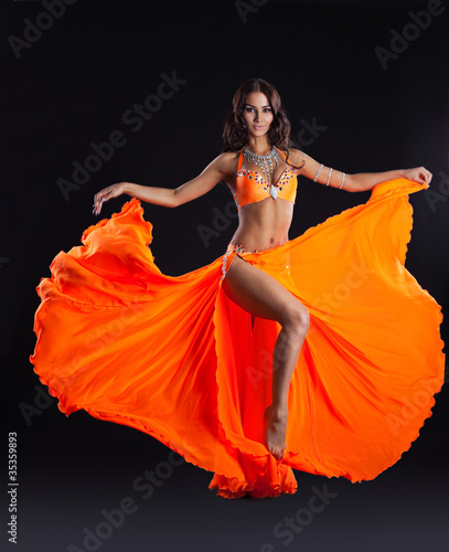 beauty dancer posing in orange veil - arabia style photo