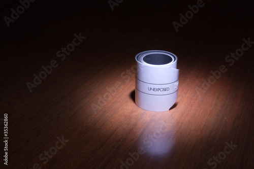 a 120 photographic film unexposed in the light on a wood table