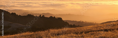 Panorama of California Bay Area fog at sunset.