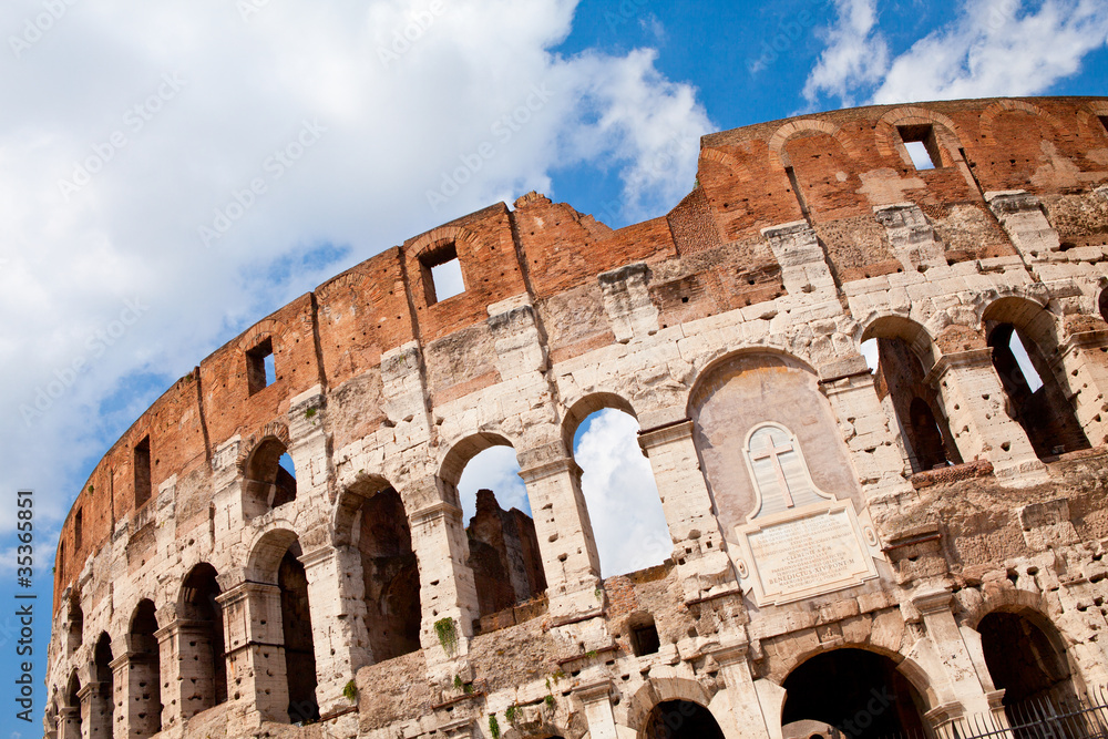 Arched facade of ancient landmark amphitheatre Colosseum in Rome