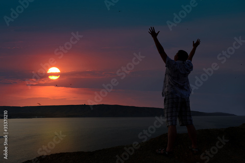 The man welcomes the sunset sun