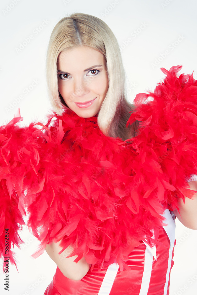 Young beautiful fashion woman posing in studio in a red boa Young beautiful fashion woman posing in studio in a red boa