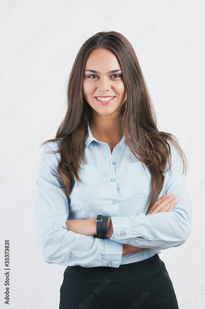 Portrait of a happy young business woman standing with folded ha Portrait of a happy young business woman standing with folded ha