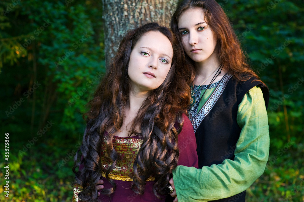 Fototapeta premium Two women in medieval dresses hugging