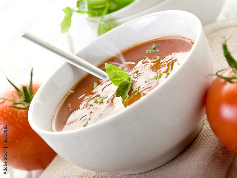 tomato soup with basil leaf on bowl tomato soup with basil leaf on bowl