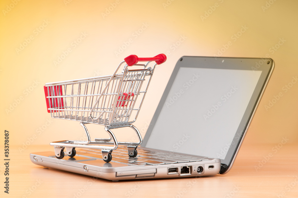Internet online shopping concept with computer and cart Internet online shopping concept with computer and cart
