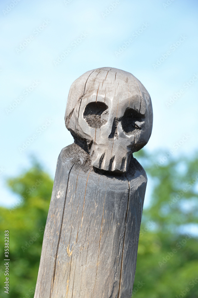 Wooden skull sculpture on the end of a pole Stock Photo | Adobe Stock
