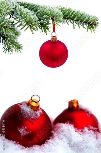 Christmas tree and red glass ball on snow background