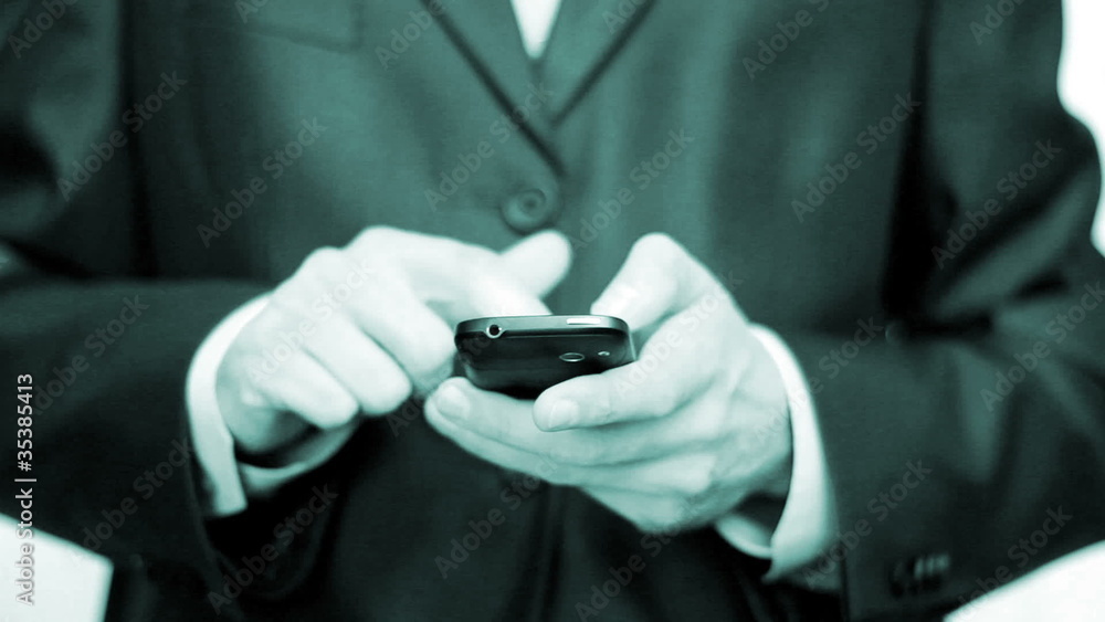 Businessman using mobile phone for text messaging Businessman using mobile phone for text messaging