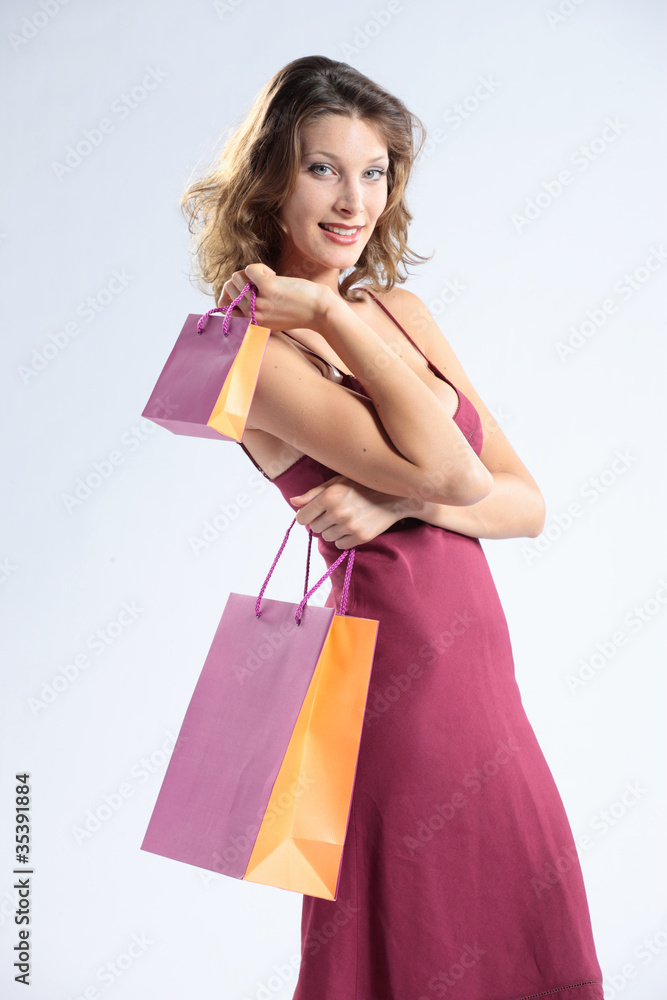 Woman holding shopping bags against a white background