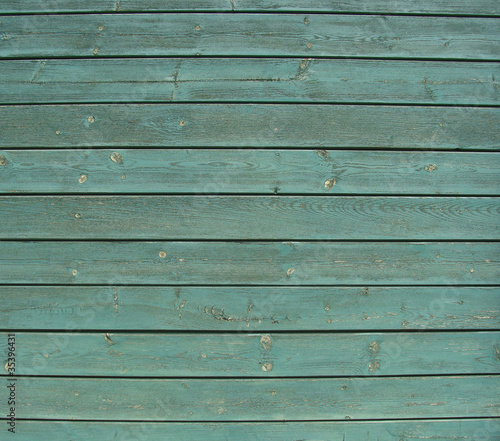 planks of green painted wooden timber fence