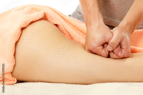 masseur makes anticellulite massage young woman isolated on whit photo