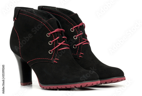 Pair of black female boots over white