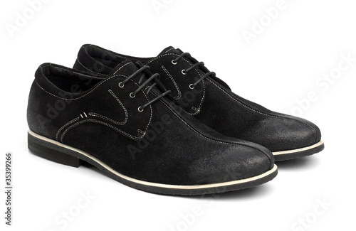 Pair of black male shoes over white