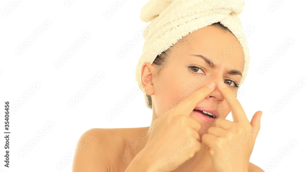 Attractive young woman searching for pimples, isolated Attractive young woman searching for pimples, isolated