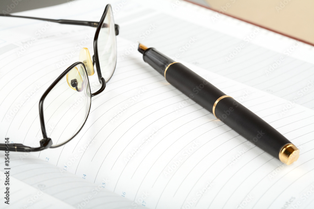Business a still-life with fountain pen and glasses Business a still-life with fountain pen and glasses